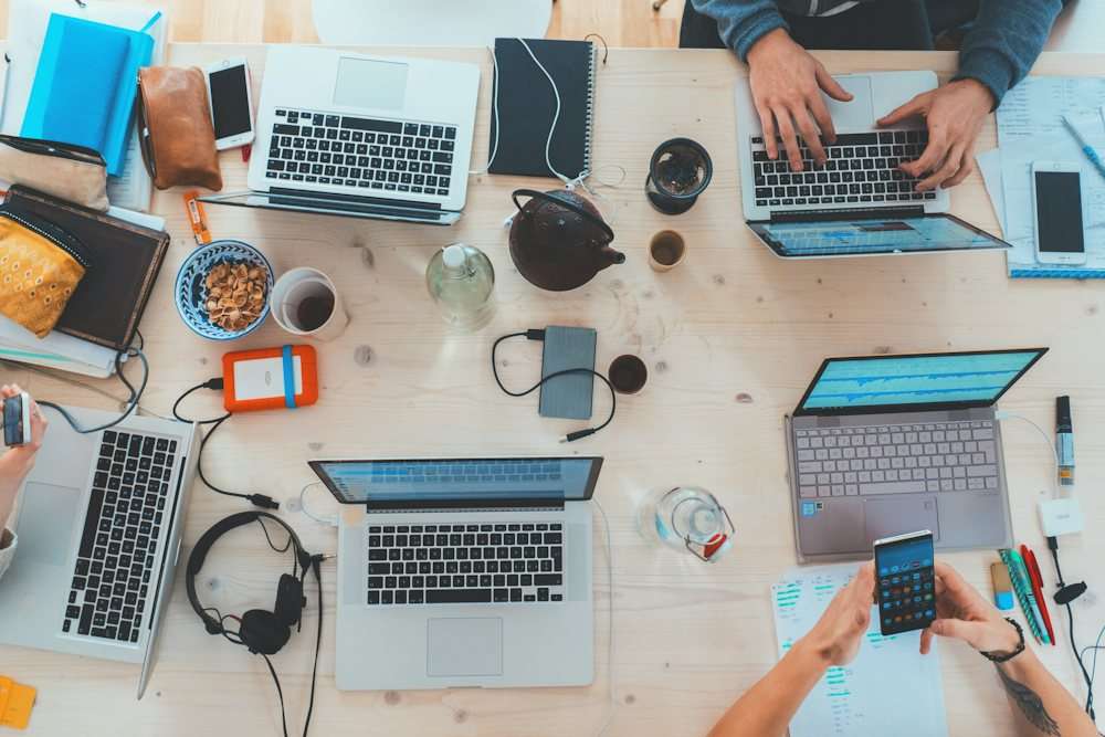 Team workspace with laptops from above